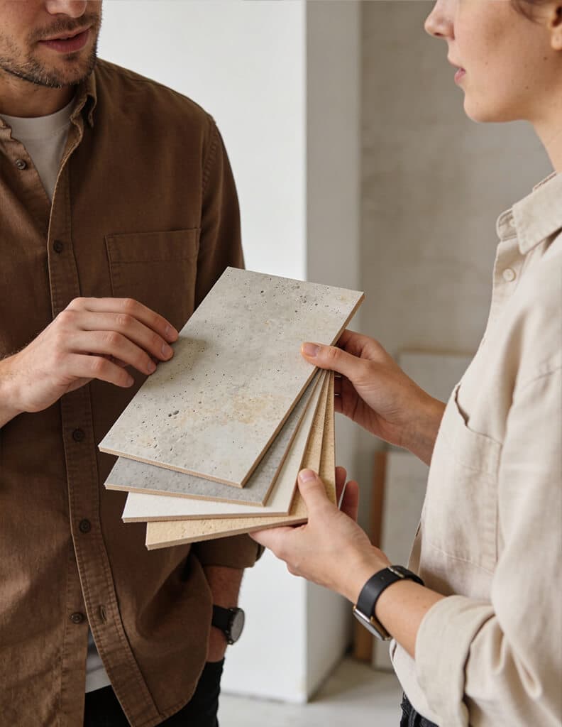 Two professionals looking over sample boards with decorative finishes together